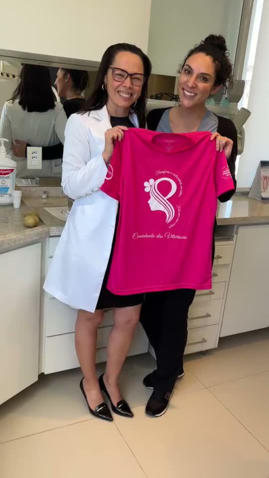 Dra. Fernanda e participante apresentando a camiseta rosa do IMAMA